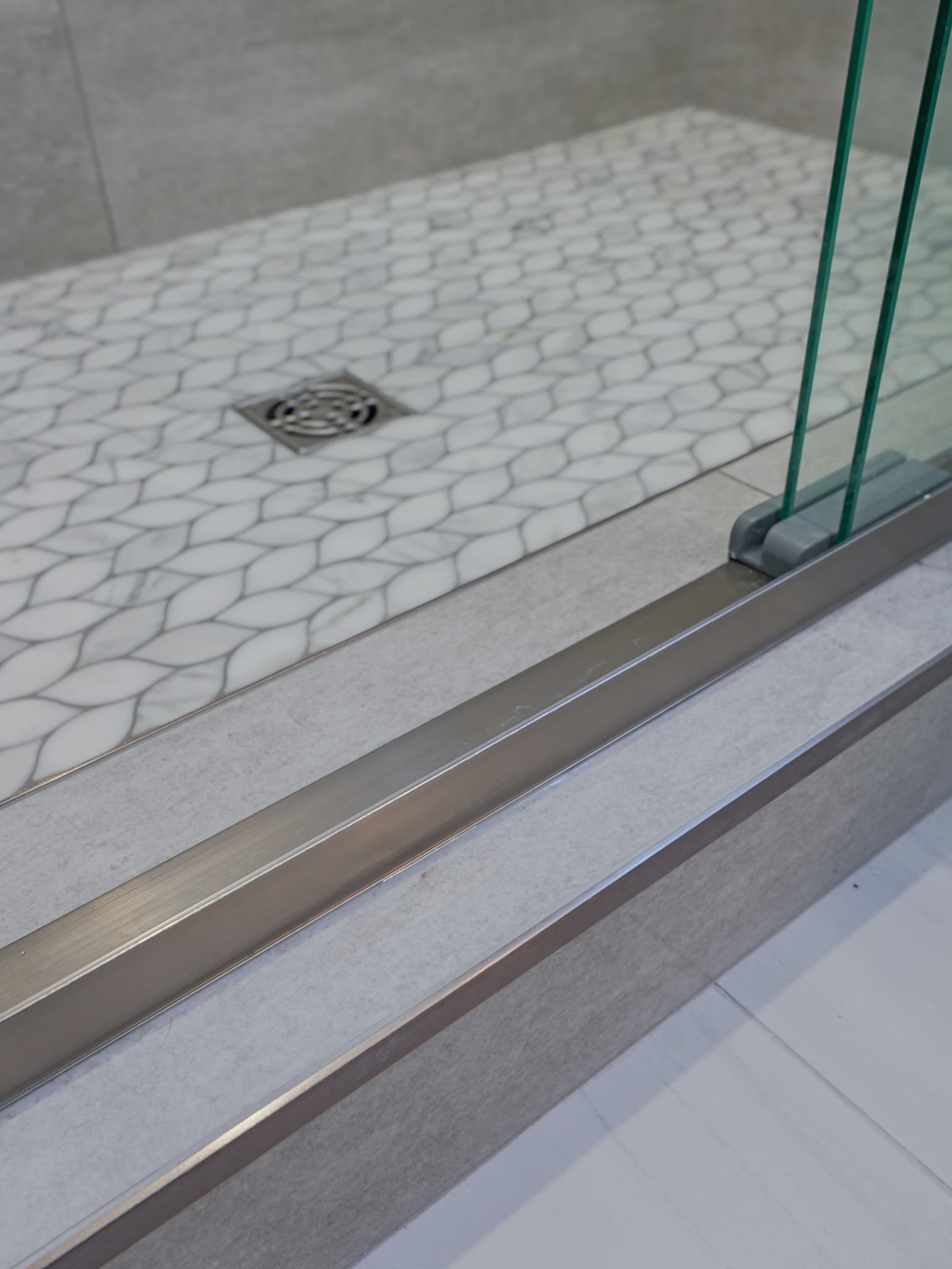 Bathroom Remodel in Sacramento — walk-in shower, frameless glass shower, tiled shower surround, mosaic backsplash, porcelain tile flooring