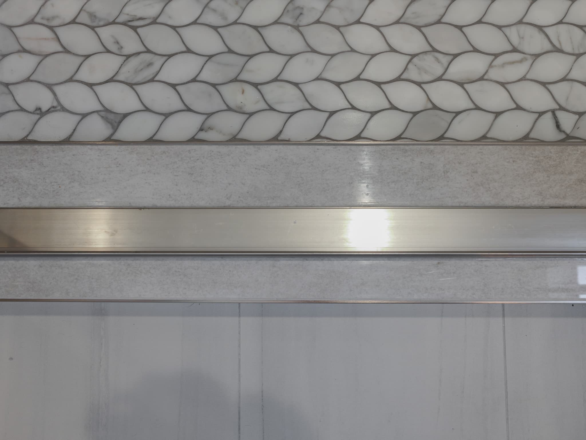 Bathroom Remodel in Sacramento — mosaic backsplash, natural-stone backsplash, marble tile flooring, tiled shower surround, wainscoting