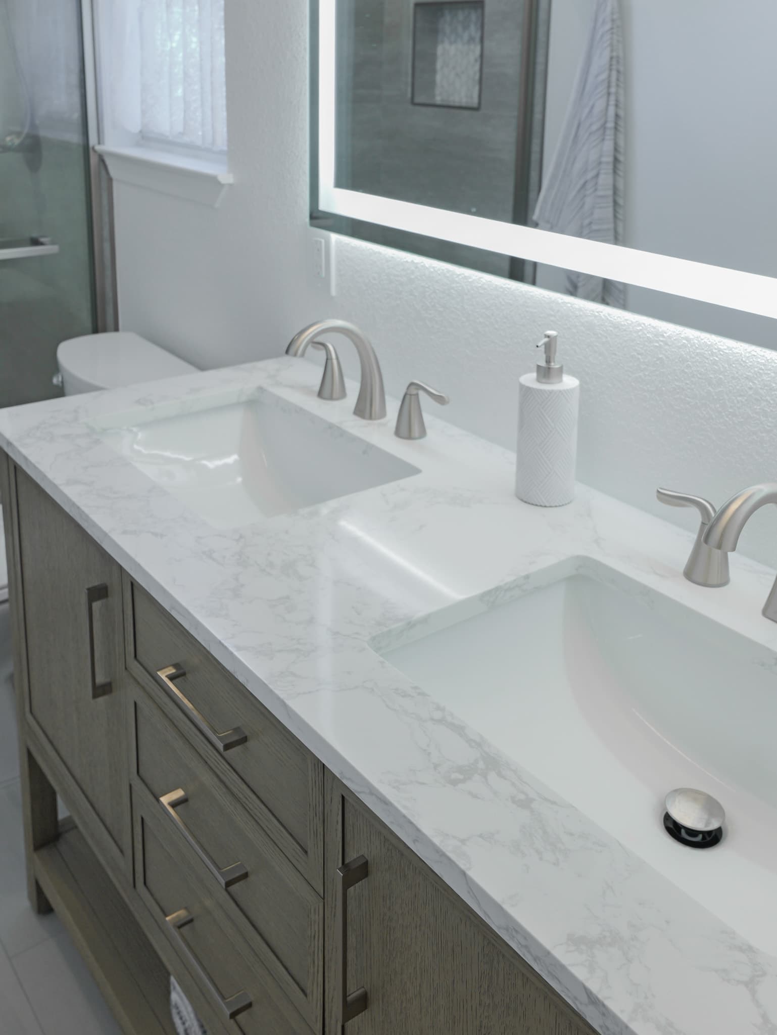 Bathroom Remodel in Sacramento — double vanity, undermount sink, quartz countertop, lighted mirror, shaker cabinets