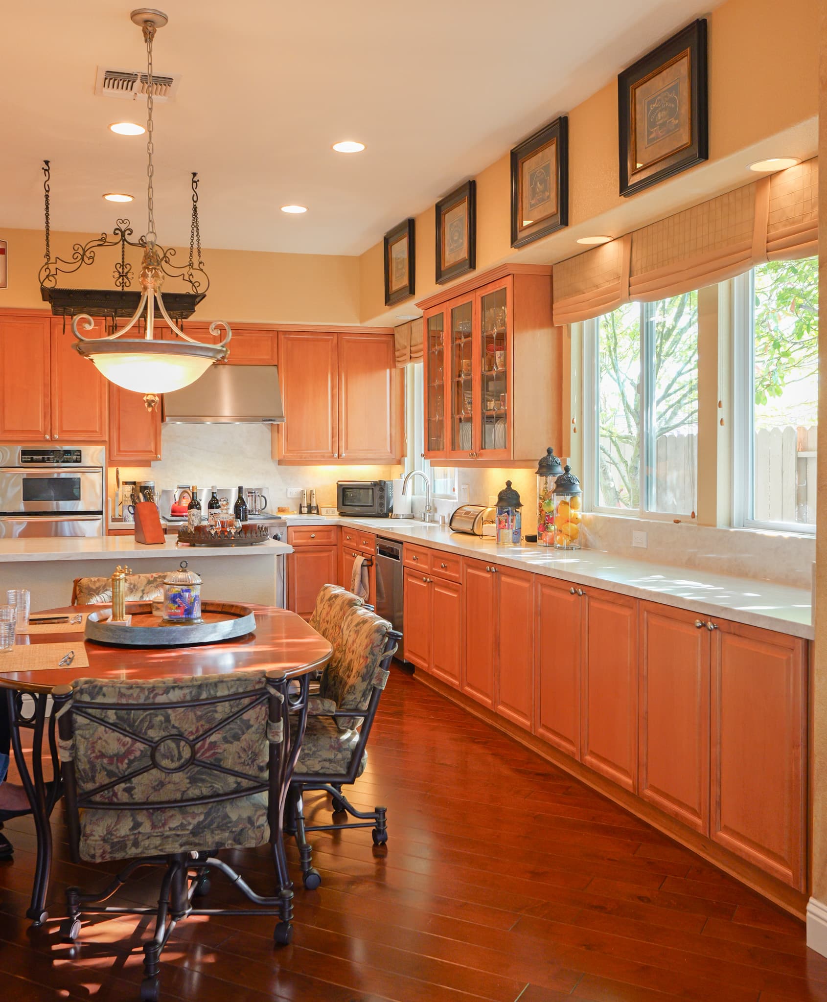 Kitchen Remodel in Roseville — raised-panel cabinets, recessed lighting, pendant lighting, under-cabinet lighting, hardwood flooring