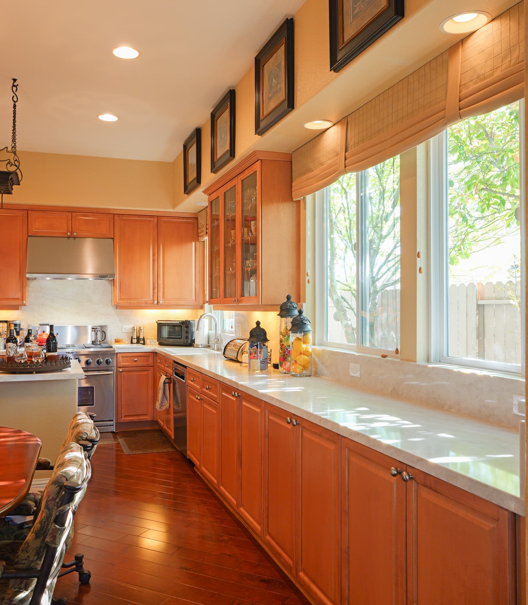 Kitchen Remodel in Roseville — raised-panel cabinets, recessed lighting, under-cabinet lighting, hardwood flooring, range hood