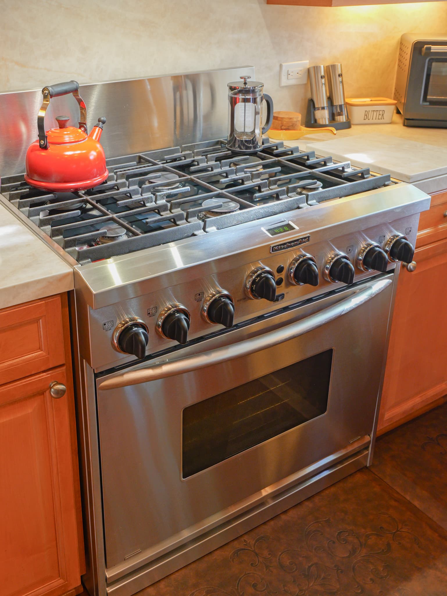 Kitchen Remodel in Roseville — professional gas range, stainless appliances, raised-panel cabinets, quartz countertop, hardwood flooring