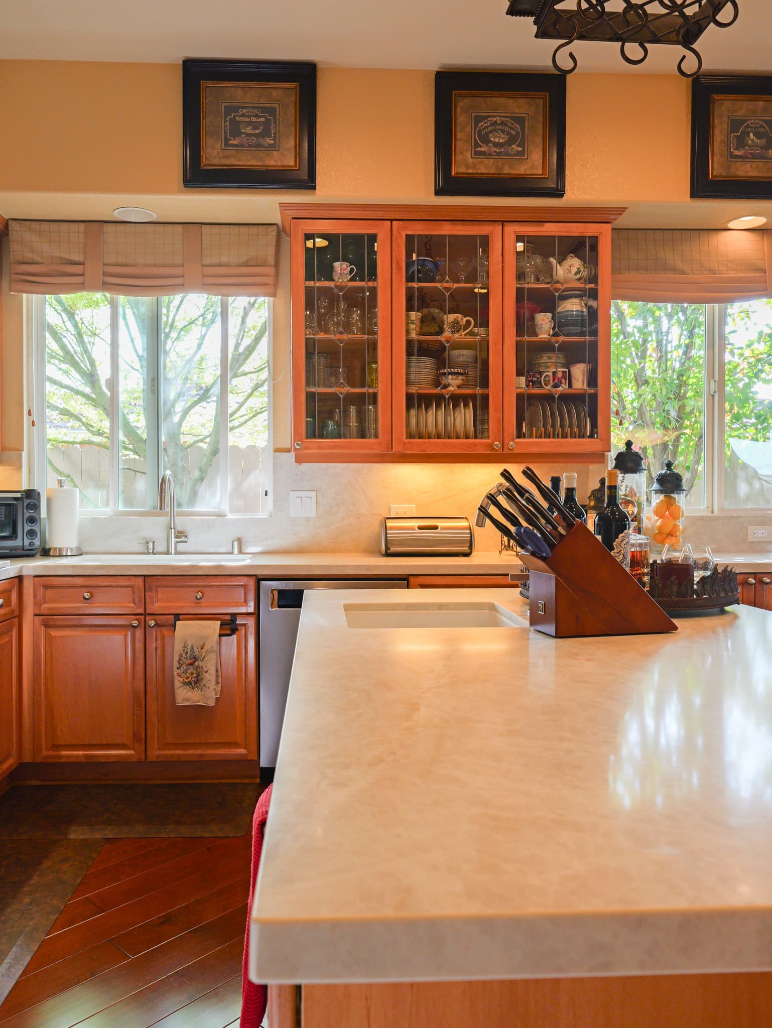 Kitchen Remodel in Roseville — raised-panel cabinets, kitchen island, quartz countertop, under-cabinet lighting, hardwood flooring