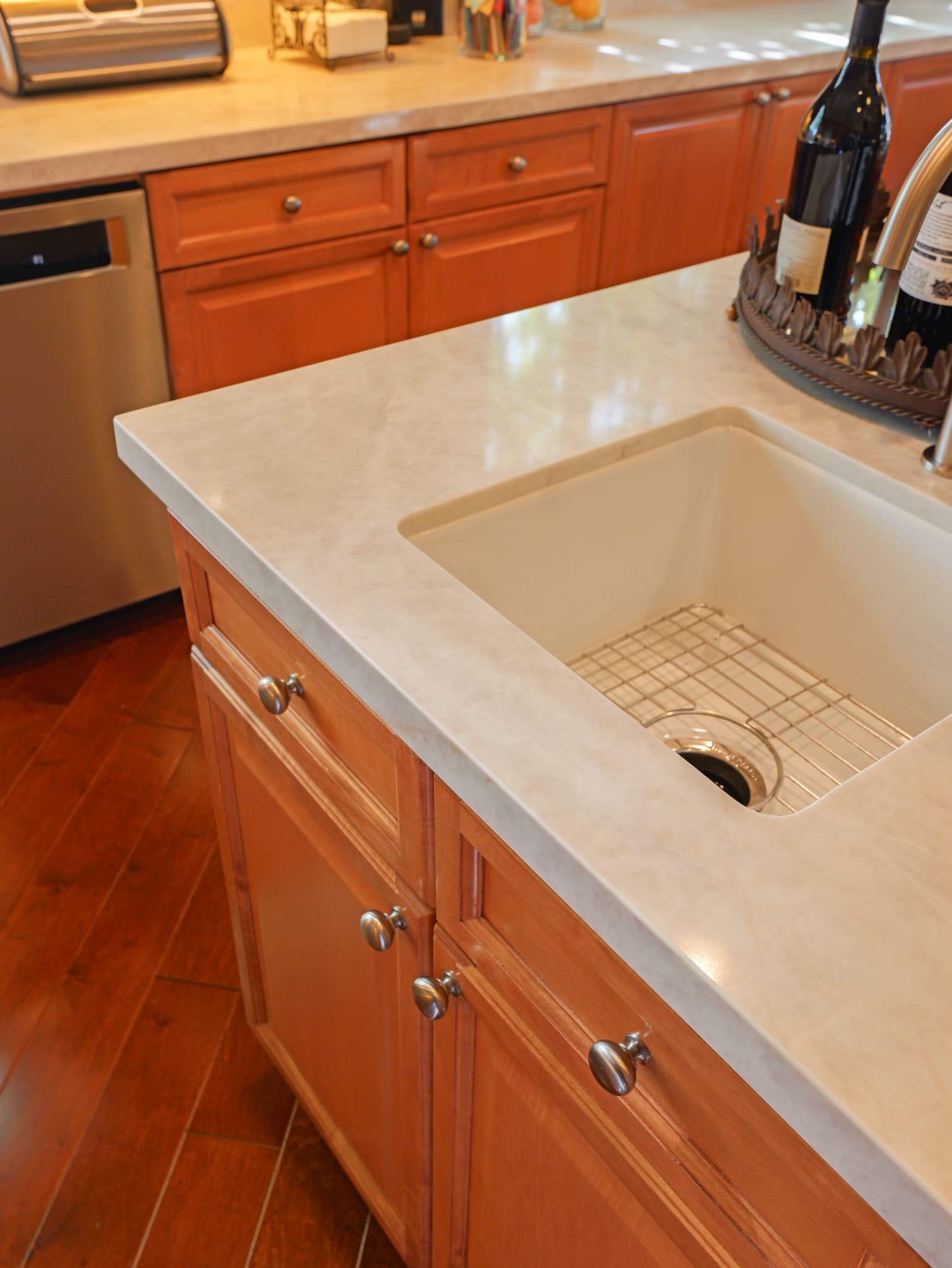 Kitchen Remodel in Roseville — kitchen island, farmhouse sink, quartz countertop, raised-panel cabinets, hardwood flooring