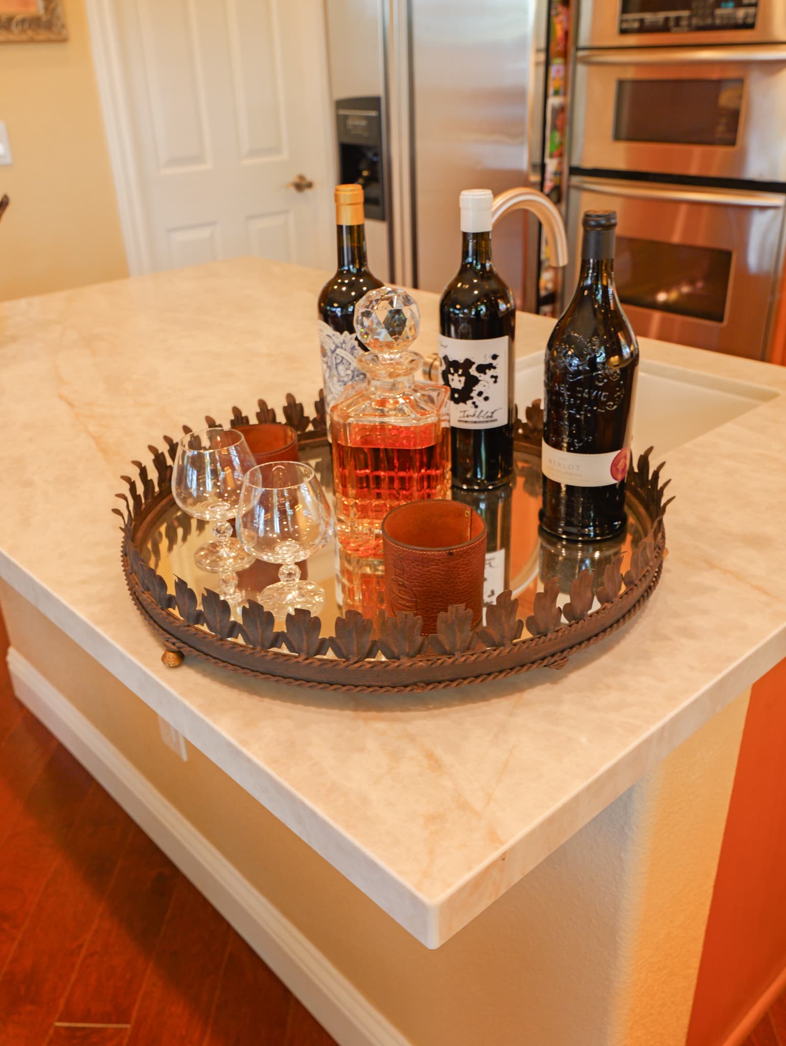 Kitchen Remodel in Roseville — kitchen island, marble countertop, stainless appliances, double oven, hardwood flooring